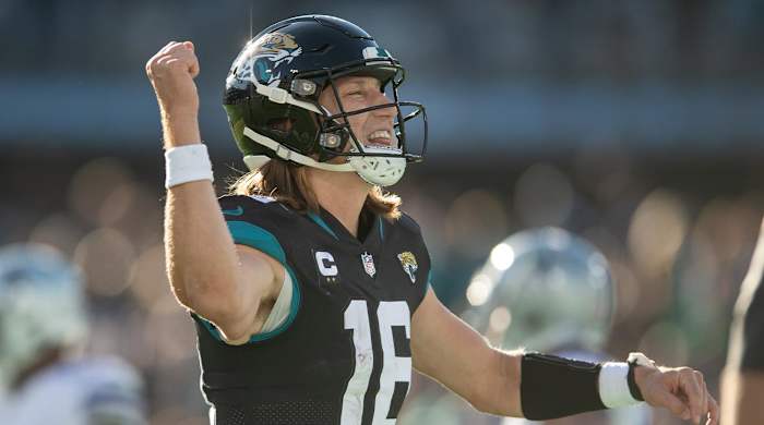 Dec 18, 2022; Jacksonville, Florida, USA; Jacksonville Jaguars quarterback Trevor Lawrence (16) celebrates a touchdown against the Dallas Cowboys in the fourth quarter at TIAA Bank Field.